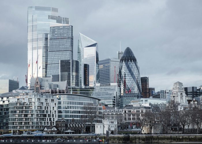 Modern multistory business centers with geometric architecture located on street against cloudy sky in downtown of London city in financial district